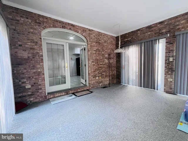 a view of an empty room window and fire place