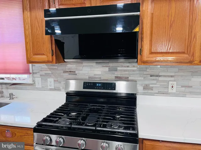 a stove top oven sitting inside of a kitchen
