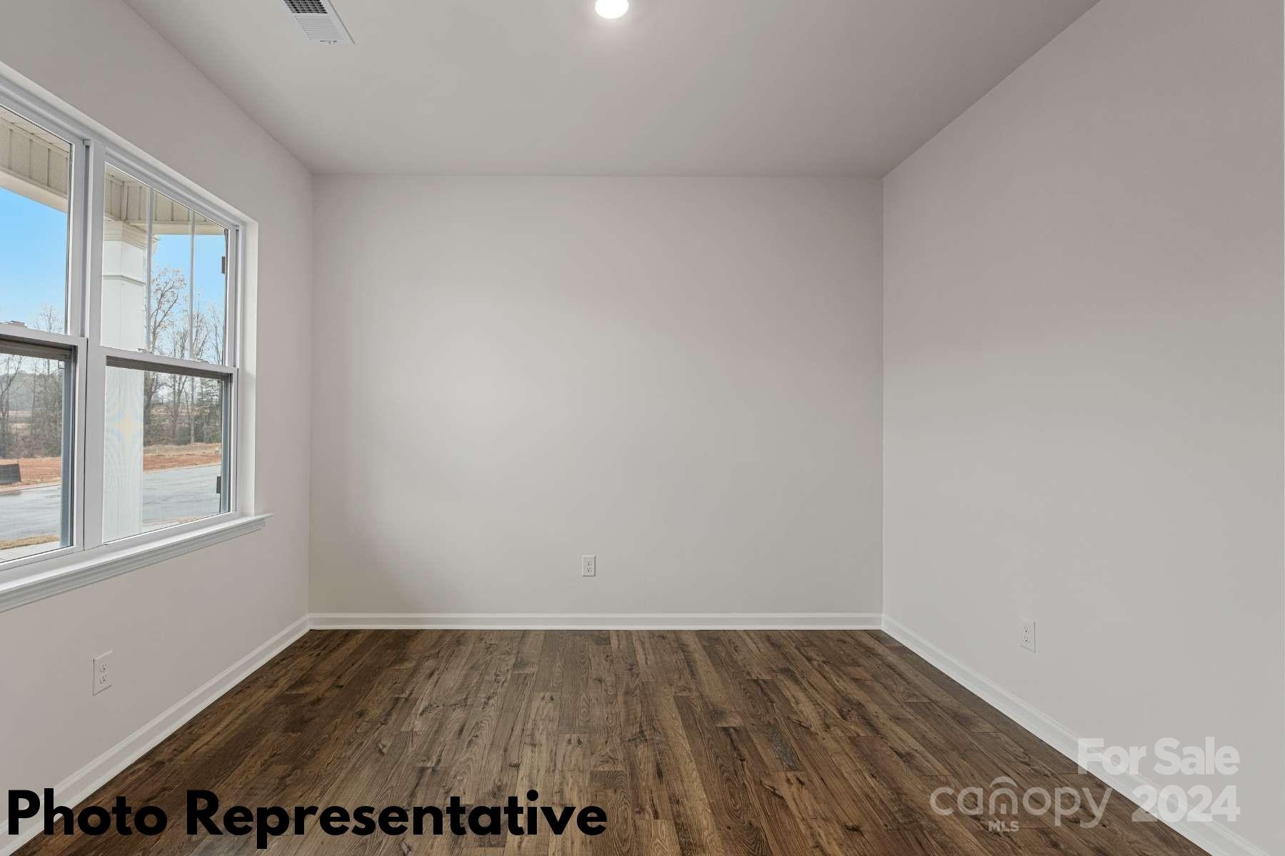160 Dandelion Road Fletcher, NC 28732 - Photo 3 of 28 a view of an empty room with wooden floor and a window