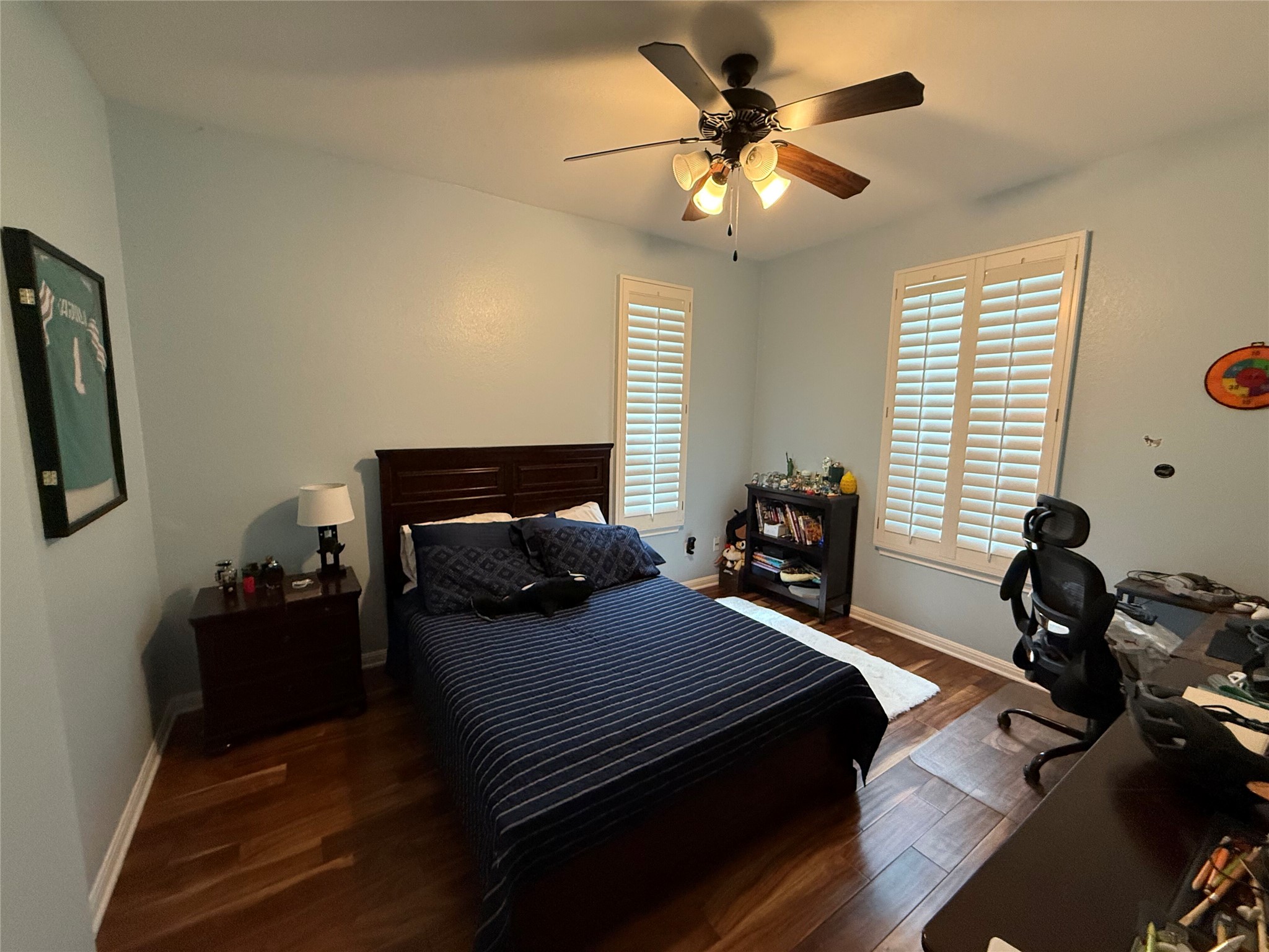 11000 Anderson Mill Road, Unit 93 Austin, TX 78750 - Photo 12 of 27 Well-lit sleeping quarters featuring hardwood flooring and ample natural light through window treatments.