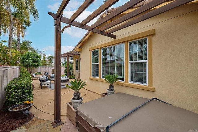 a living room with furniture and potted plants
