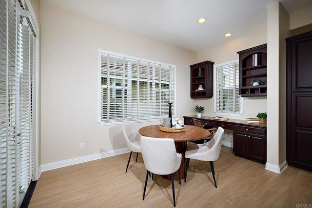 a bedroom with a large bed and windows