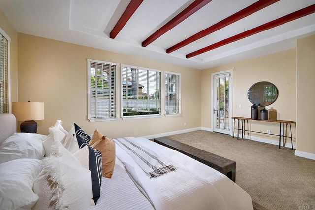 a spacious bedroom with a bed and a large window