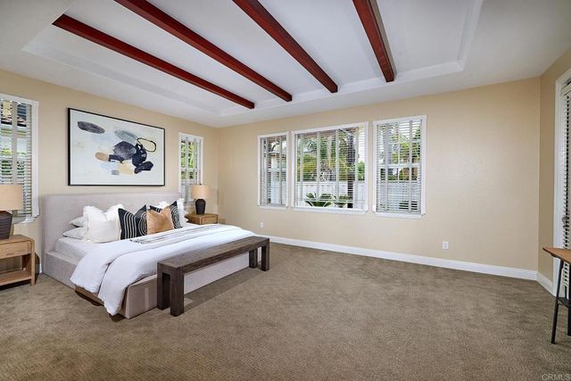 a spacious bathroom with a tub double sink and mirror