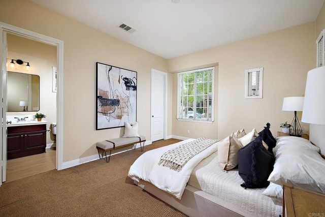 a bathroom with a sink vanity mirror and toilet