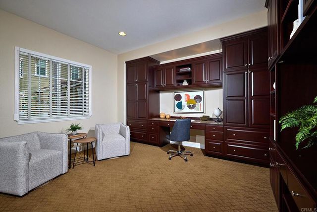 an aerial view of residential houses with outdoor space and ocean