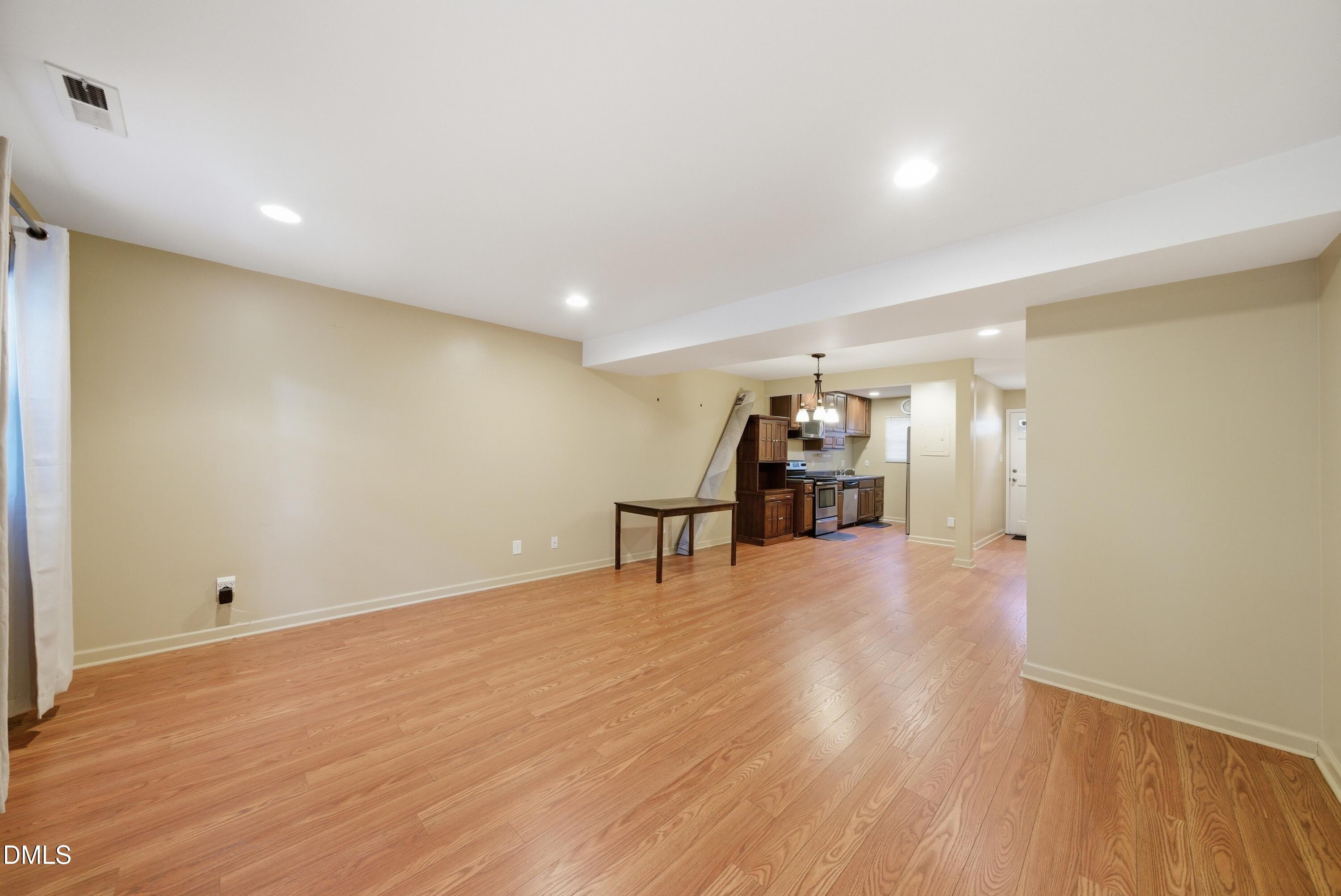 6355 New Market Way Raleigh, NC 27615 - Photo 19 of 30 a view of empty room with wooden floor