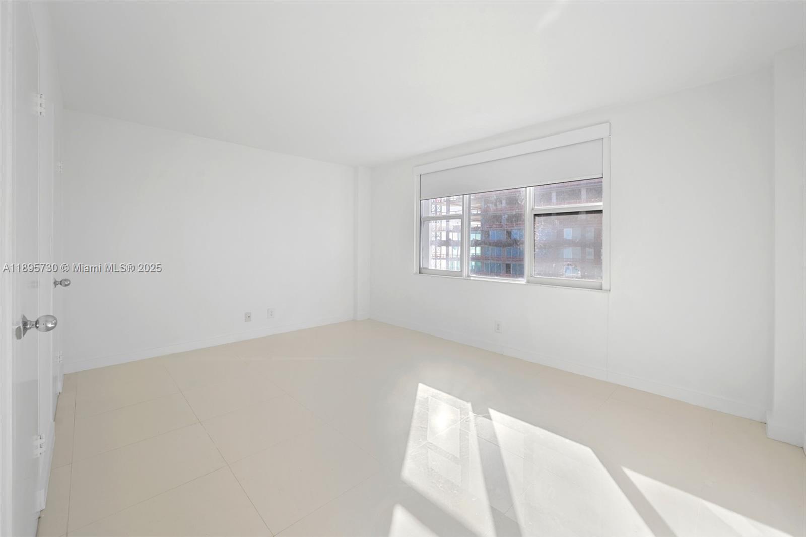 9195 Collins Avenue, Unit 812 Surfside, FL 33154 - Photo 15 of 20 a view of an empty room with a window