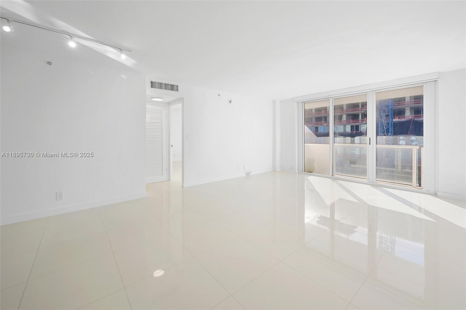 9195 Collins Avenue, Unit 812 Surfside, FL 33154 - Photo 16 of 20 a view of an empty room with a window