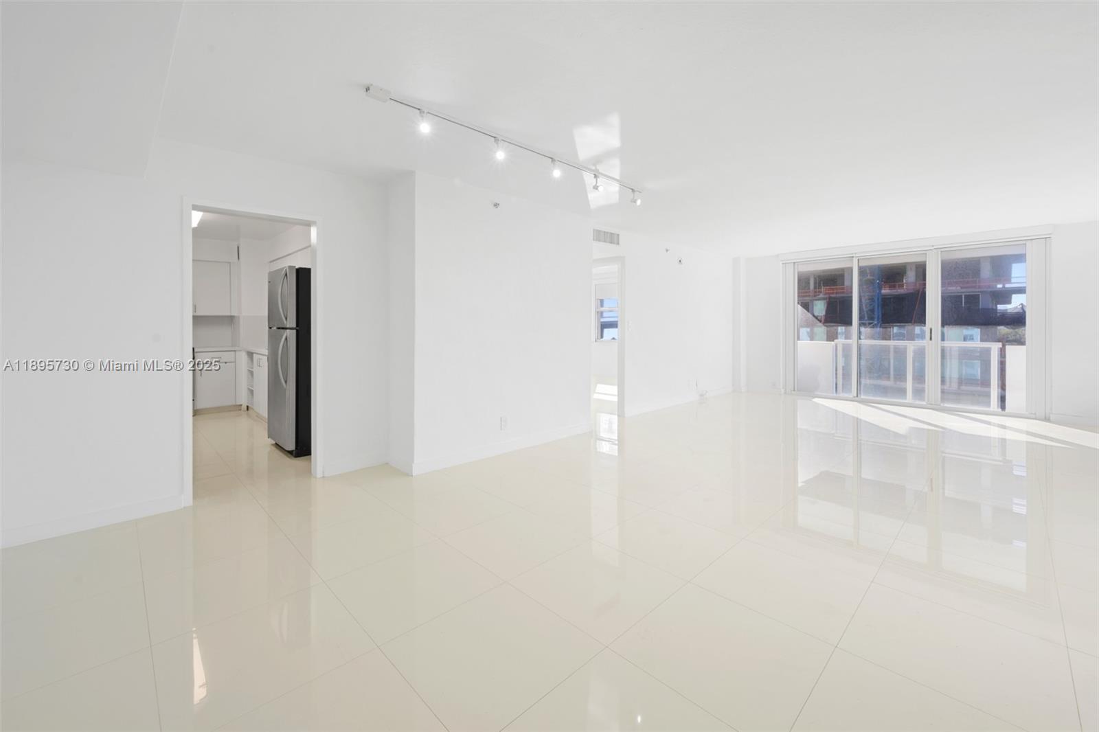 9195 Collins Avenue, Unit 812 Surfside, FL 33154 - Photo 19 of 20 en empty room with windows and entrance