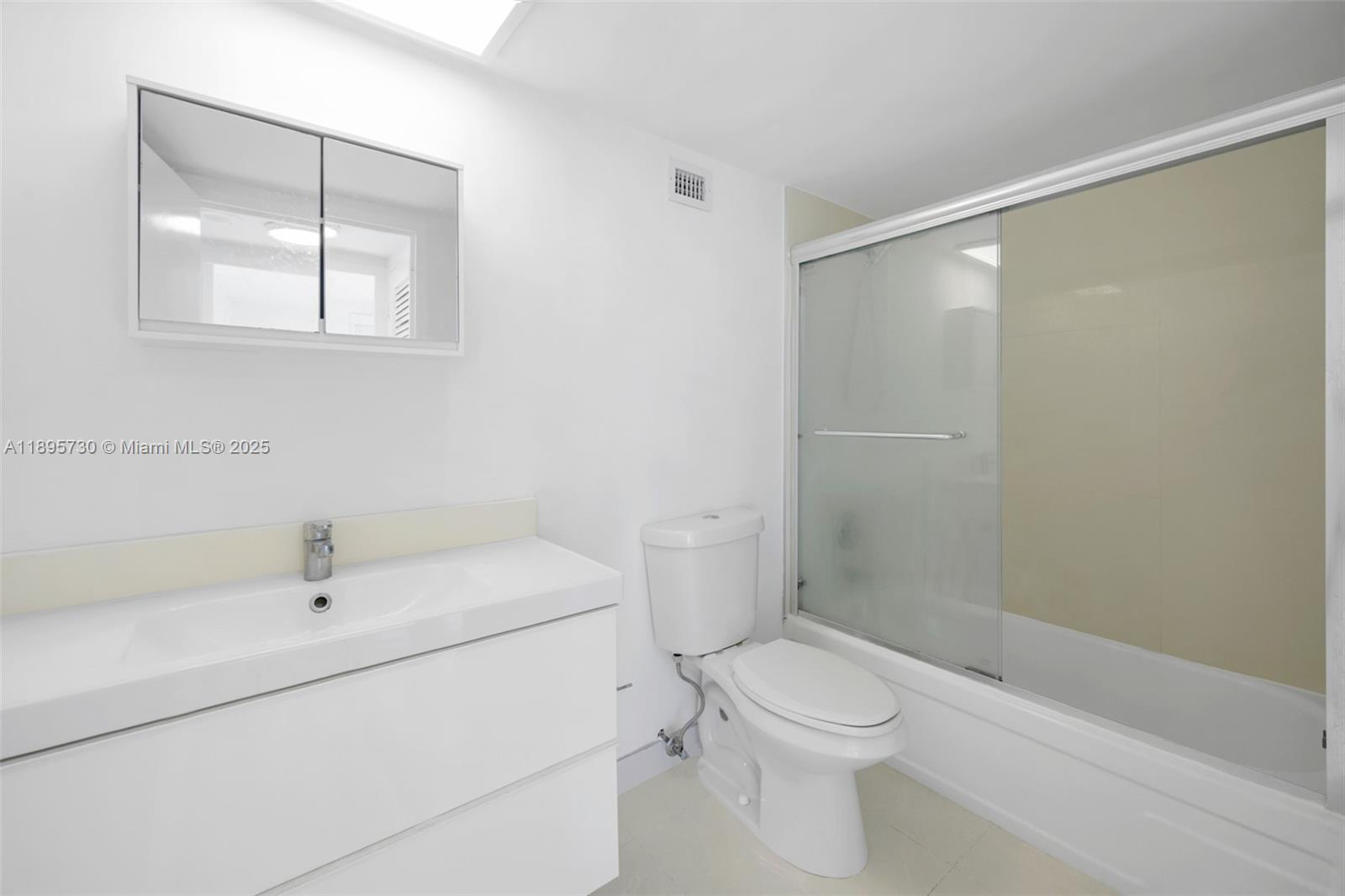 9195 Collins Avenue, Unit 812 Surfside, FL 33154 - Photo 9 of 20 a bathroom with a sink a toilet and shower