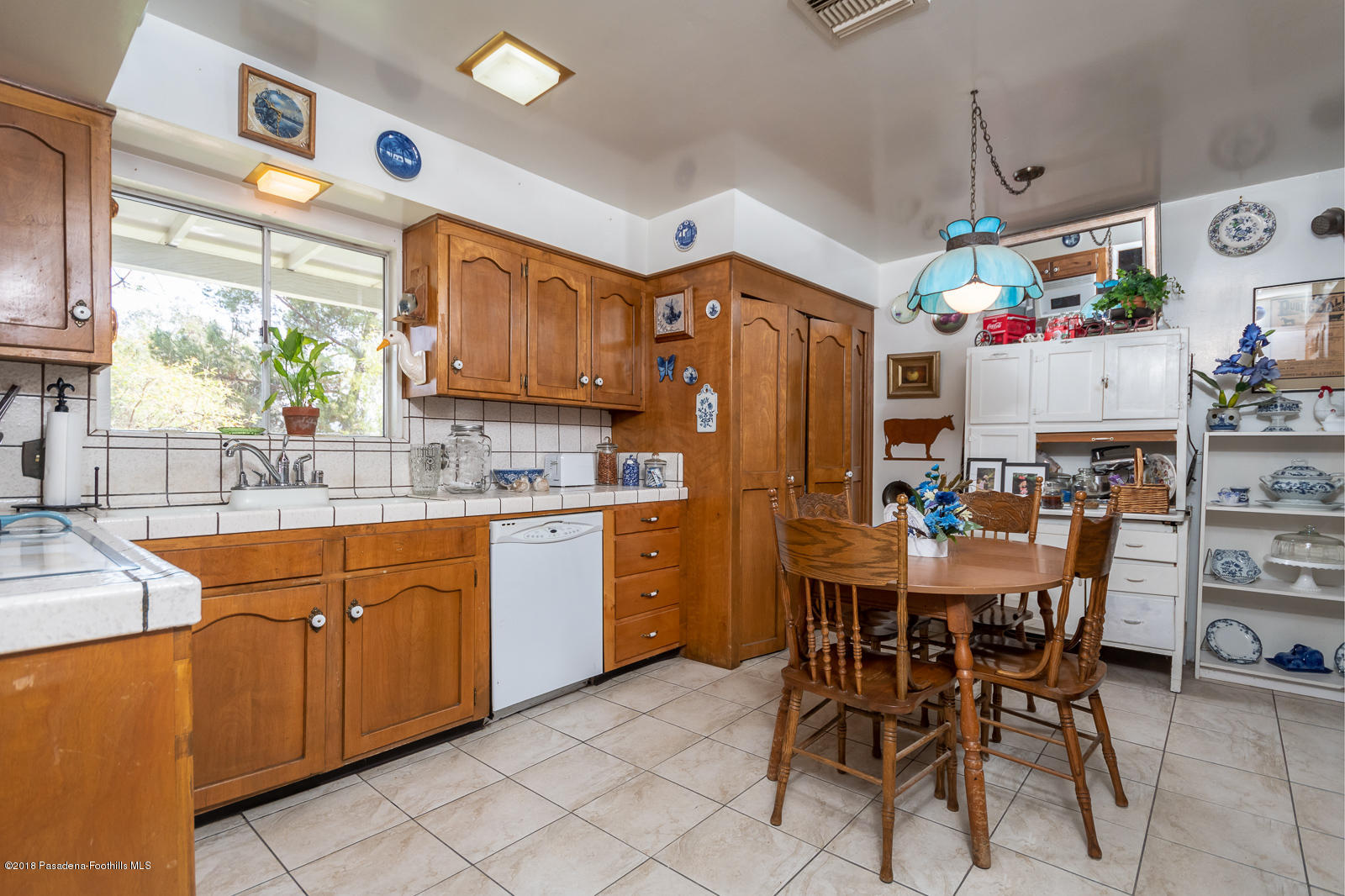 7871 Denivelle Road Sunland, CA 91040 - Photo 14 of 48 a kitchen with stainless steel appliances kitchen island granite countertop dining room and chairs