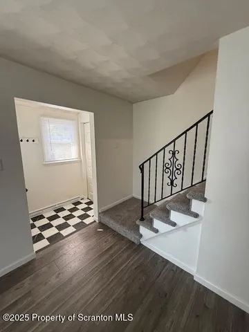 a view of entryway with wooden floor