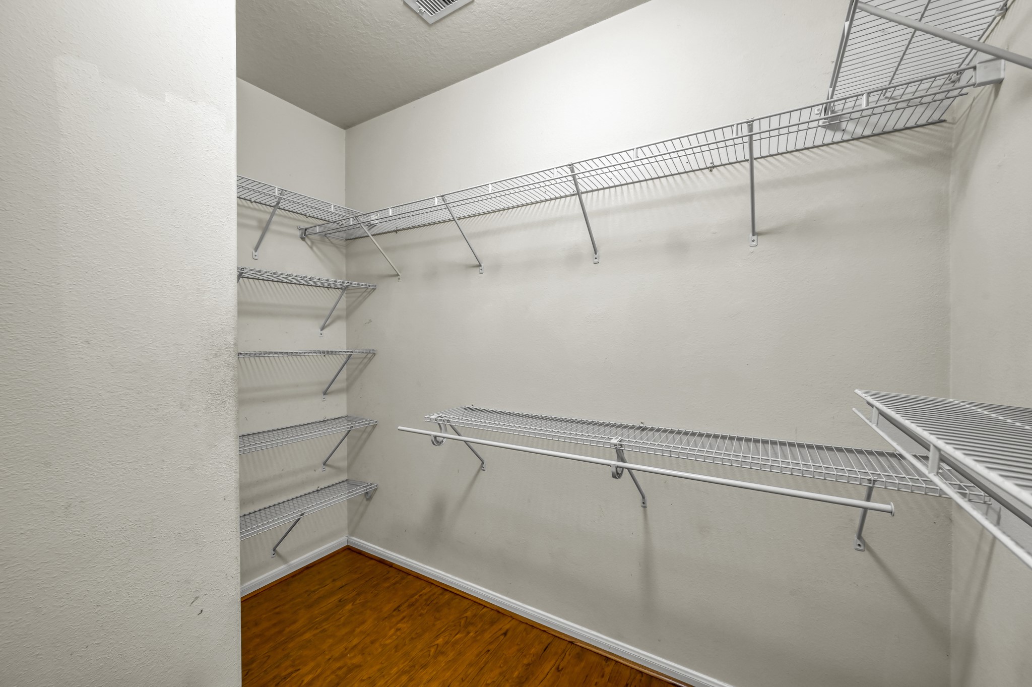 631 Timberstand Lane Spring, TX 77373 - Photo 24 of 38 The oversized primary closet provides ample storage space with built-in shelving and plenty of room to stay organized.