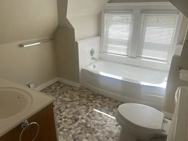 a bathroom with a sink a toilet and bathtub