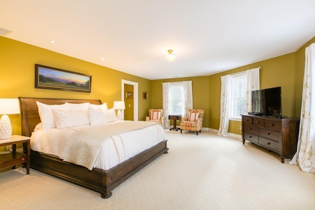 106 Koning Farm Road Carlisle, MA 01741 - Photo 15 of 39 a spacious bedroom with a bed and a flat screen television