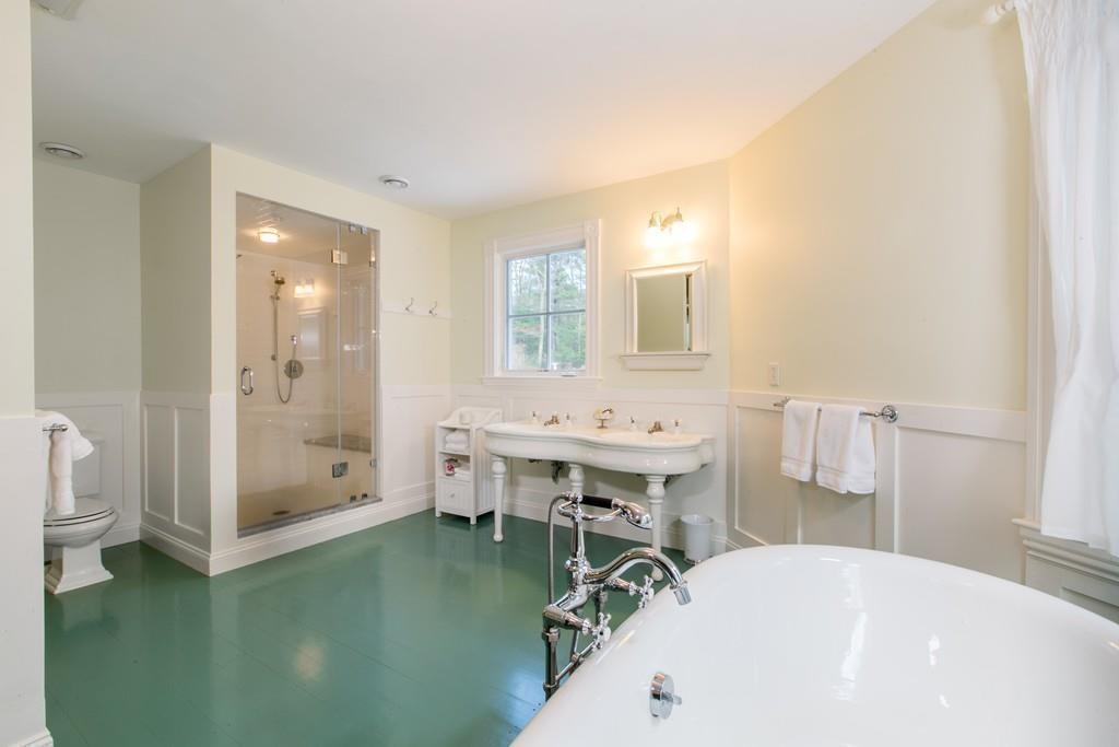 106 Koning Farm Road Carlisle, MA 01741 - Photo 18 of 39 a bathroom with a tub sink and mirror