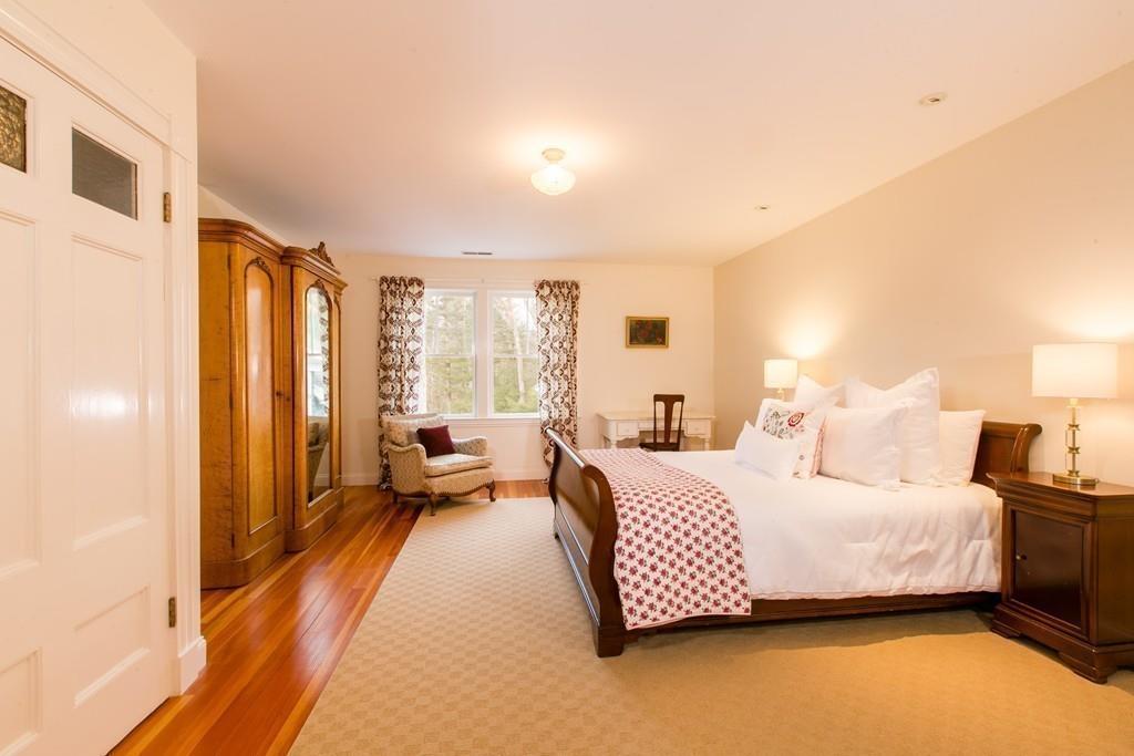 106 Koning Farm Road Carlisle, MA 01741 - Photo 22 of 39 a bedroom with a bed and wooden floor