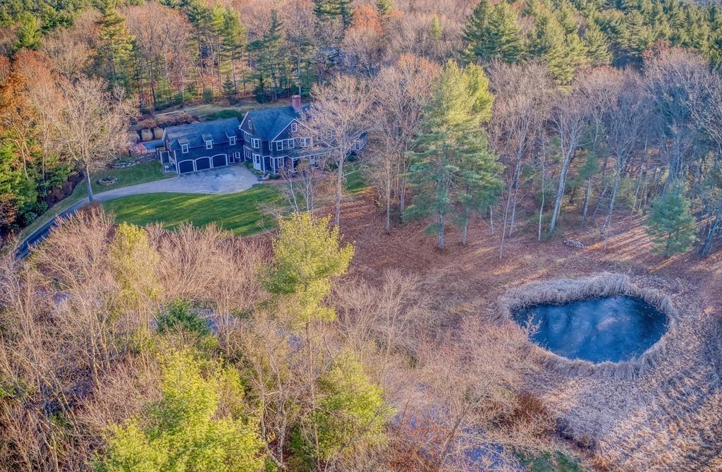 106 Koning Farm Road Carlisle, MA 01741 - Photo 35 of 39 a view of a backyard with fountain plants and large trees