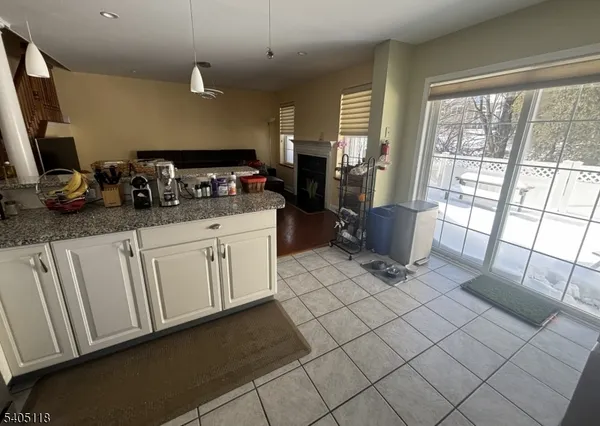 a kitchen with stainless steel appliances a stove a sink a microwave a refrigerator and cabinets