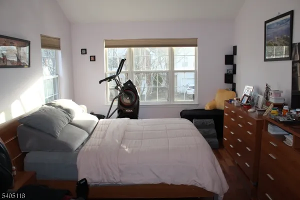 a bedroom with a bed and flat screen tv