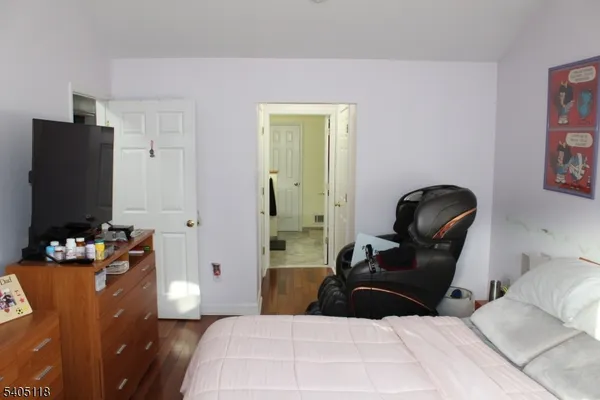 a bedroom with a bed and a white wall