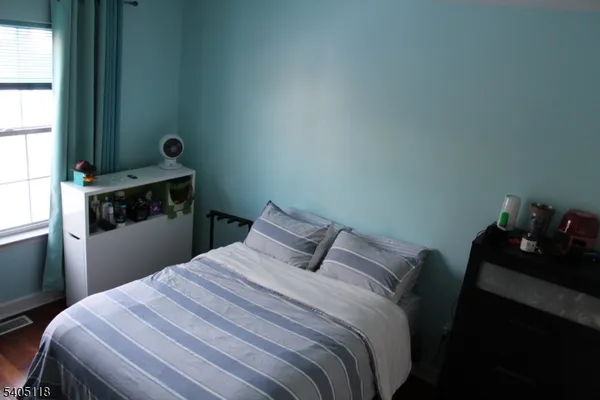 a bed room with a bed and a television