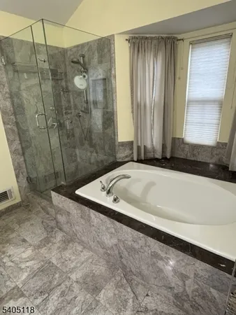 a bath tub sitting next to a shower