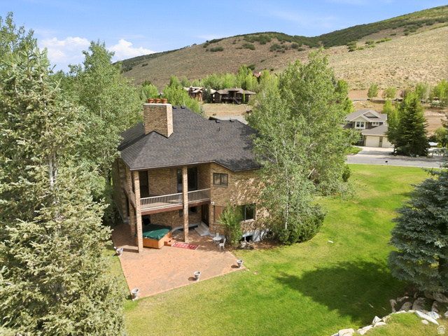 3535 Homestead Road Park City, UT 84098 - Photo 74 of 81 Brick-clad residence featuring a multi-level design, a prominent brick chimney, and a dark shingle roof