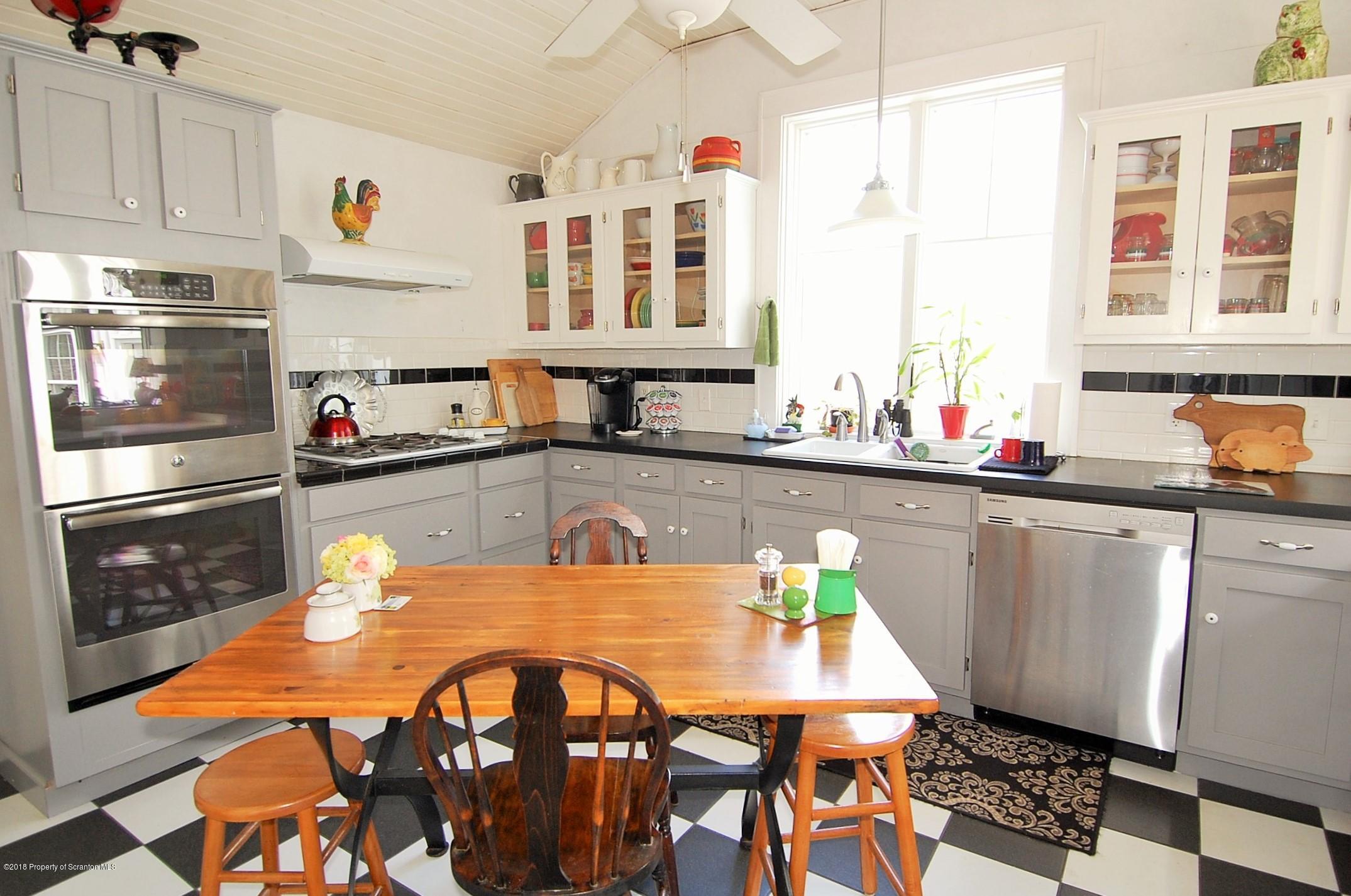 4126 State Rte 2012 Forest City, PA 18421 - Photo 11 of 66 a kitchen with a sink a stove and chairs