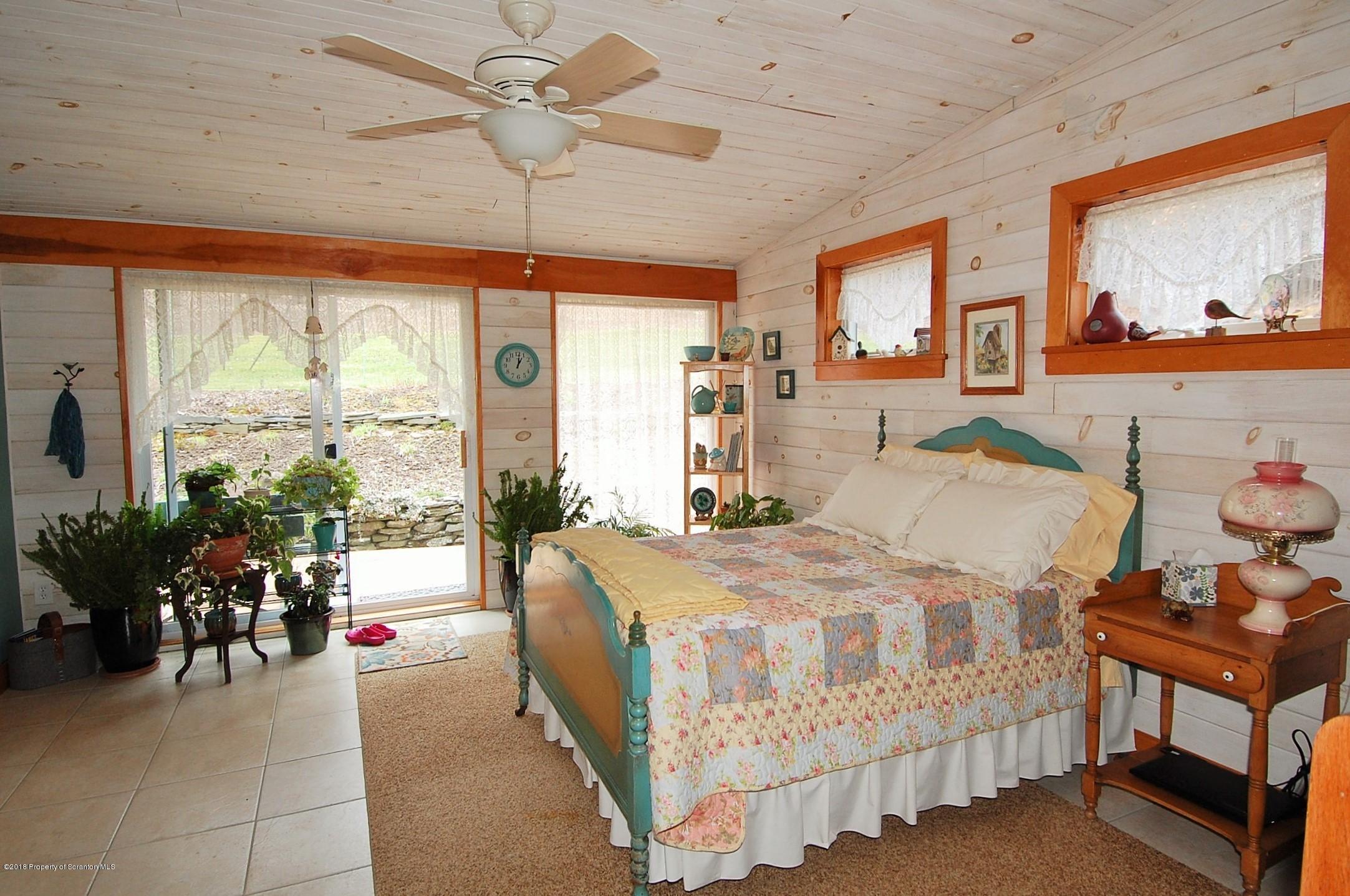4126 State Rte 2012 Forest City, PA 18421 - Photo 17 of 66 a bedroom with a bed and large windows