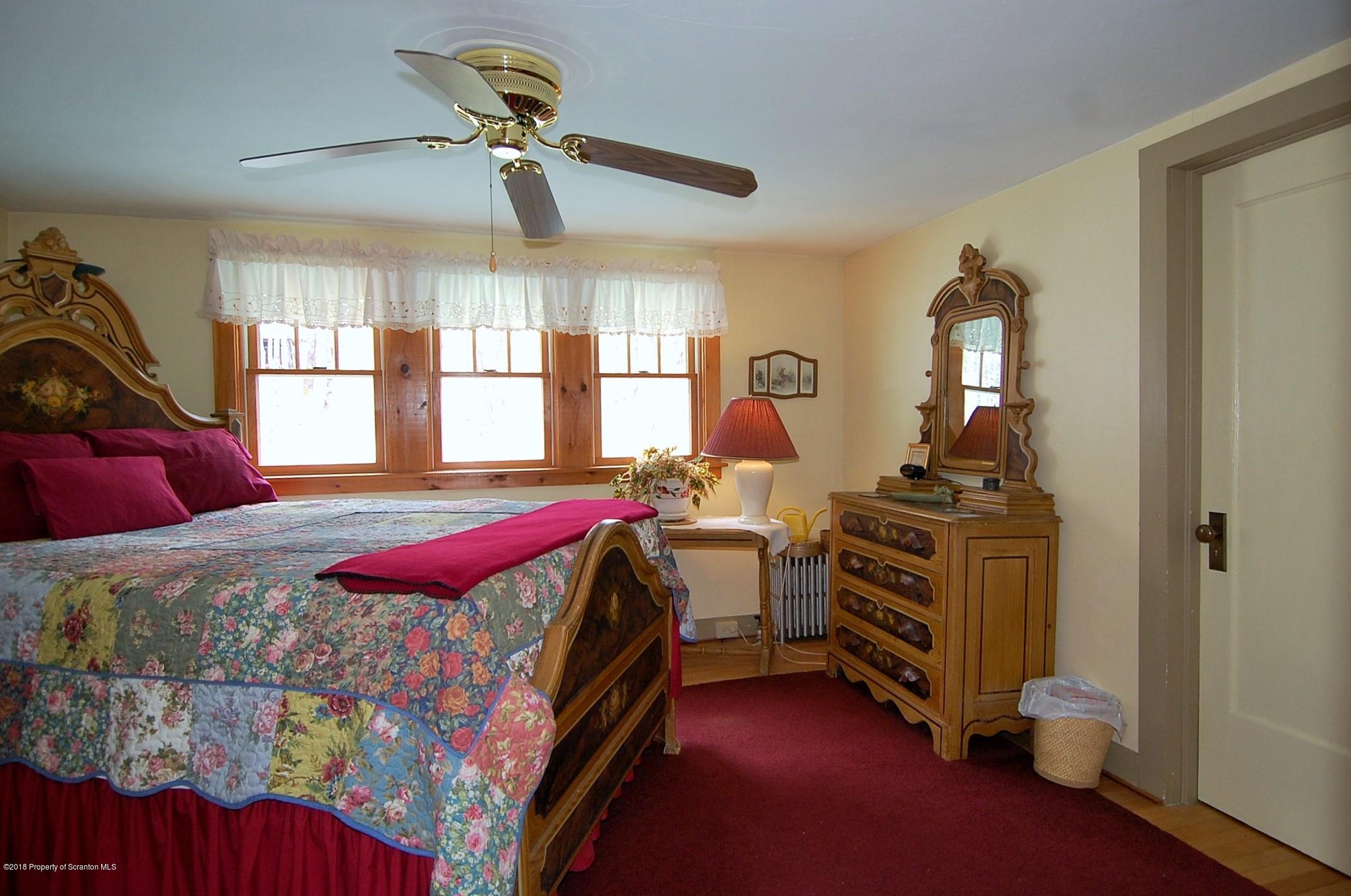 4126 State Rte 2012 Forest City, PA 18421 - Photo 29 of 66 a bedroom with a bed and wooden floor