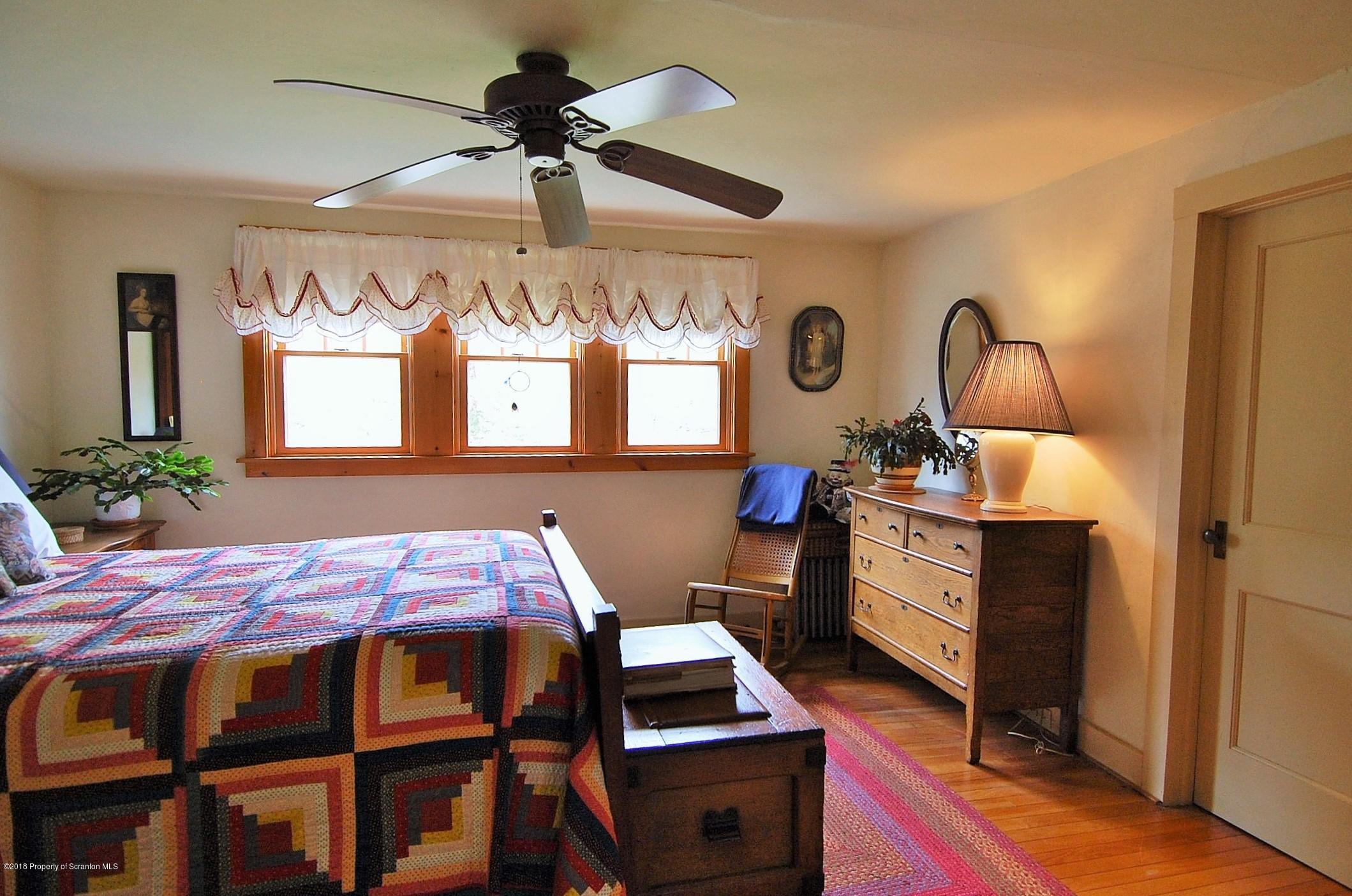 4126 State Rte 2012 Forest City, PA 18421 - Photo 33 of 66 a bedroom with a bed window and a table