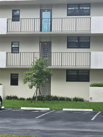 a dining room with furniture floor to ceiling windows and plants