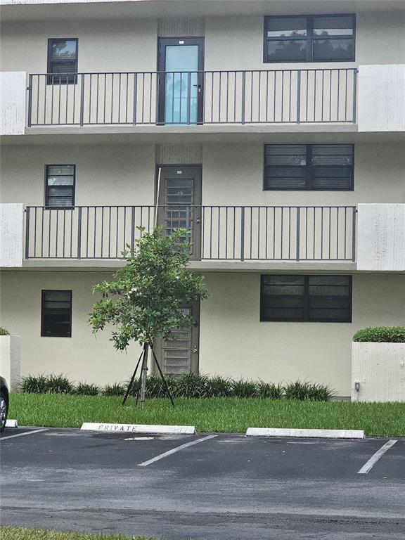 2450 DC Country Club Boulevard, Unit 203B Deerfield Beach, FL 33442 - Photo 13 of 19 a view of a house with a yard