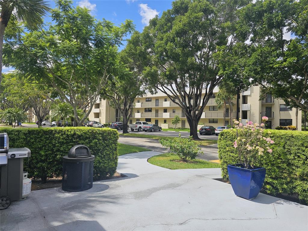 2450 DC Country Club Boulevard, Unit 203B Deerfield Beach, FL 33442 - Photo 16 of 19 a front view of a house with garden