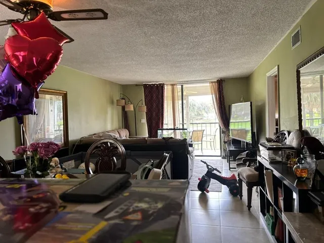 a living room with furniture a window and bookshelf