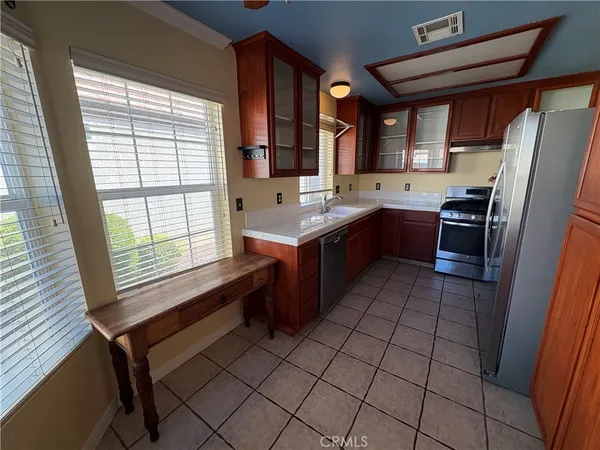 a kitchen with a sink a stove a refrigerator and cabinets