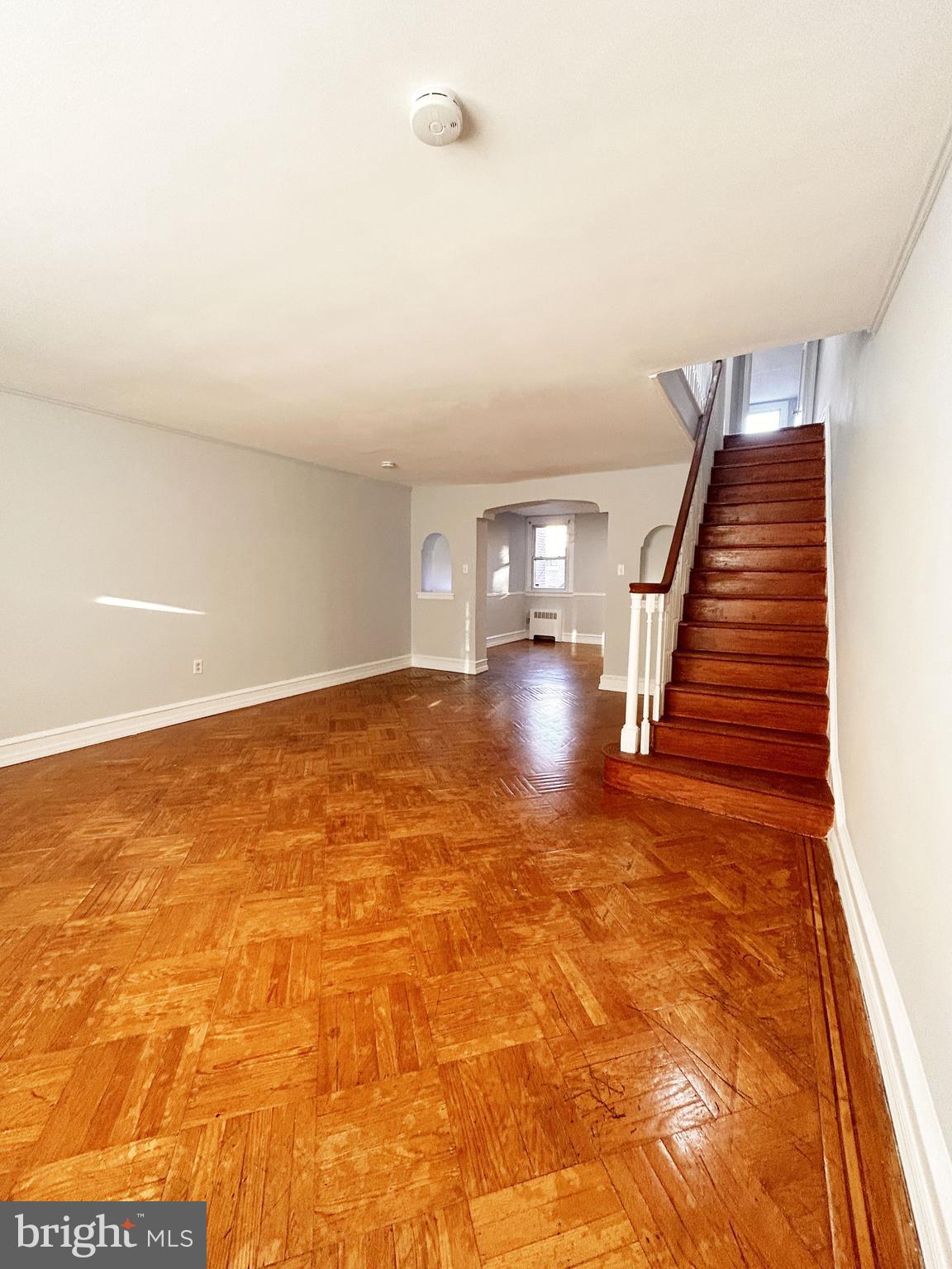 wooden floor in an empty room with stairs