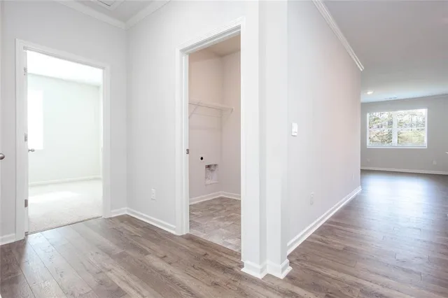 a view of a hallway with wooden floor