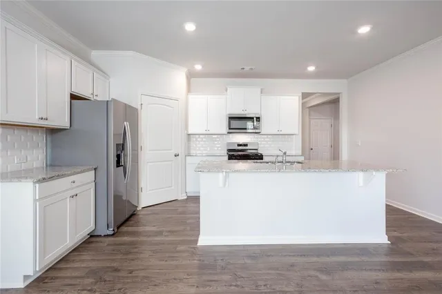 a kitchen with stainless steel appliances a refrigerator stove microwave and sink