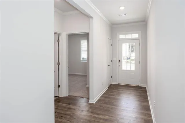 an empty room with wooden floor & closet area