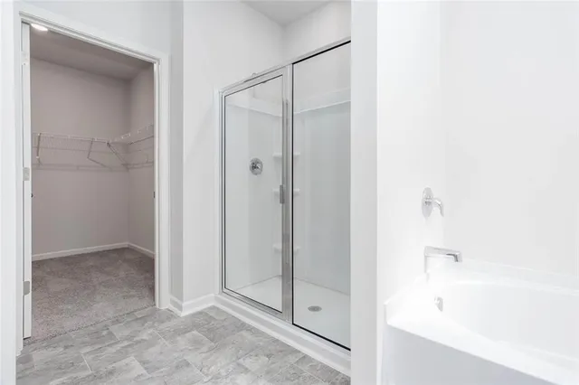 a bathroom with a shower and a glass door