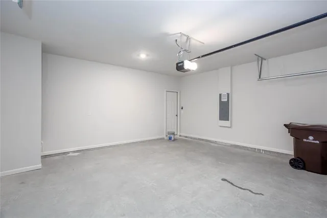 an empty room with window and ceiling fan