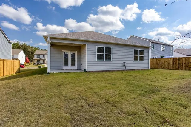 a view of a house with a backyard