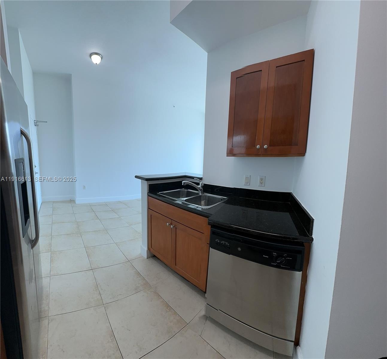 1723 Southwest 2nd Avenue, Unit PH09 Miami, FL 33129 - Photo 15 of 21 a kitchen with granite countertop a stove and a microwave