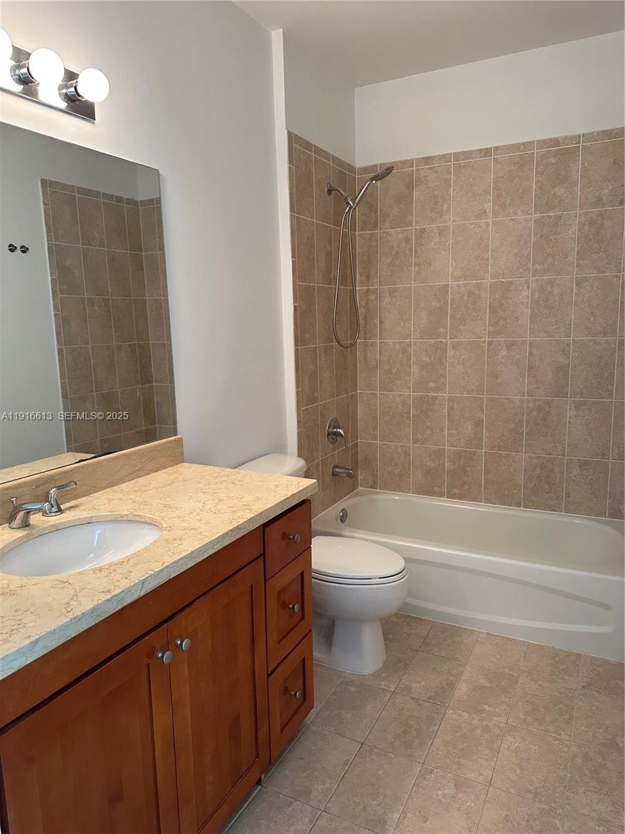 1723 Southwest 2nd Avenue, Unit PH09 Miami, FL 33129 - Photo 17 of 21 a bathroom with a granite countertop sink a toilet and bathtub