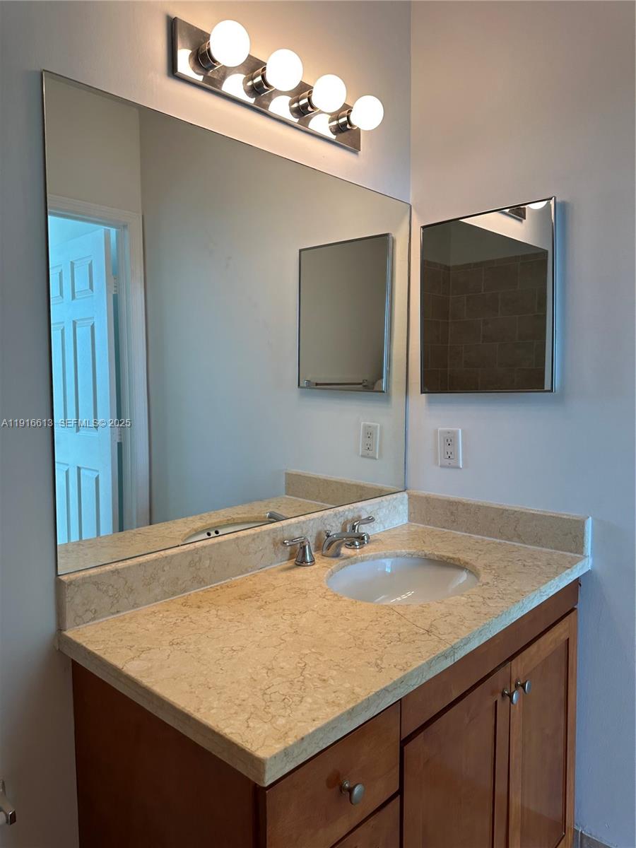 1723 Southwest 2nd Avenue, Unit PH09 Miami, FL 33129 - Photo 19 of 21 a bathroom with a sink vanity and a mirror