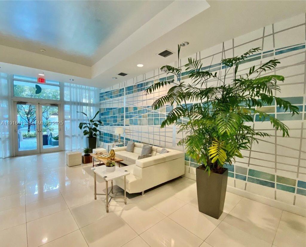 1723 Southwest 2nd Avenue, Unit PH09 Miami, FL 33129 - Photo 2 of 21 a living room with furniture flowers and potted plant