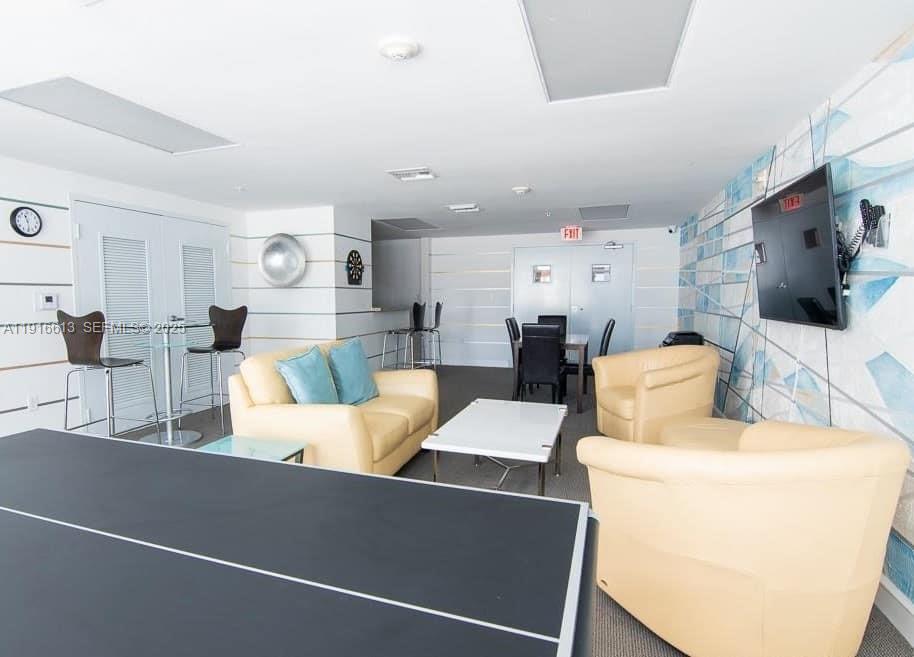 1723 Southwest 2nd Avenue, Unit PH09 Miami, FL 33129 - Photo 21 of 21 a living room with furniture and a flat screen tv